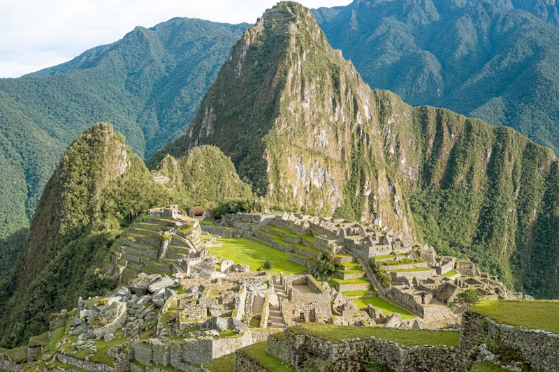 An Inca stone gateway at Machu Picchu framing the peak and ridgeline beyond