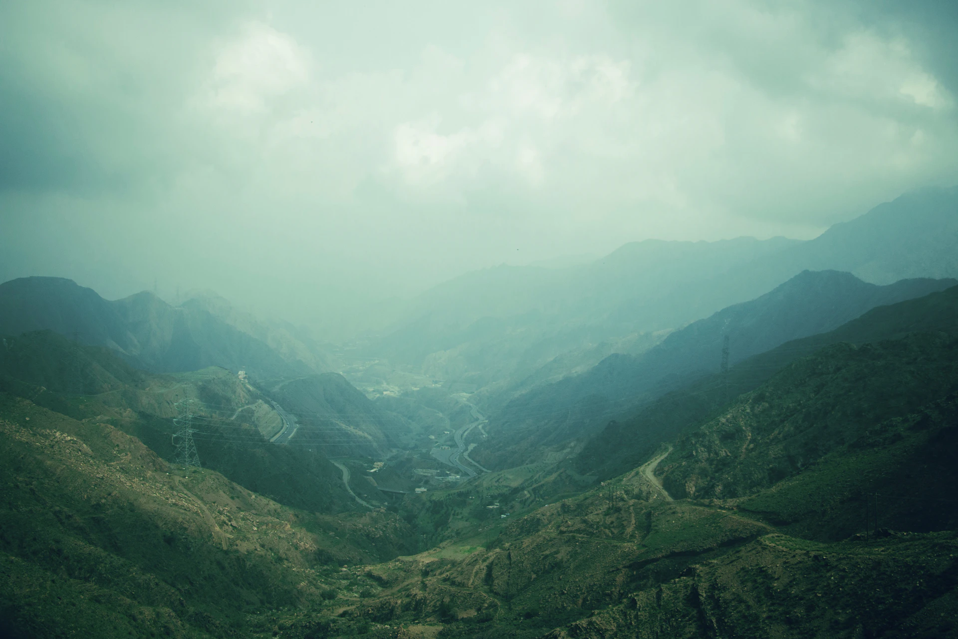 a valley with mountains in the background