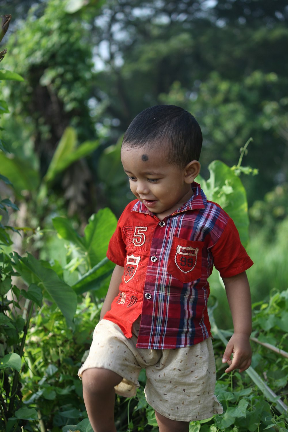 a young boy in a red shirt