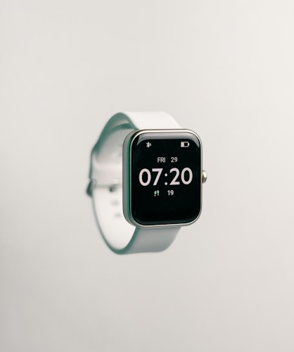 A close-up of a smartwatch displaying a heart rate reading on someone's wrist