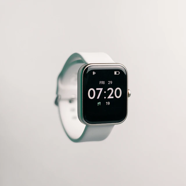 A wristwatch with a black face photographed up close