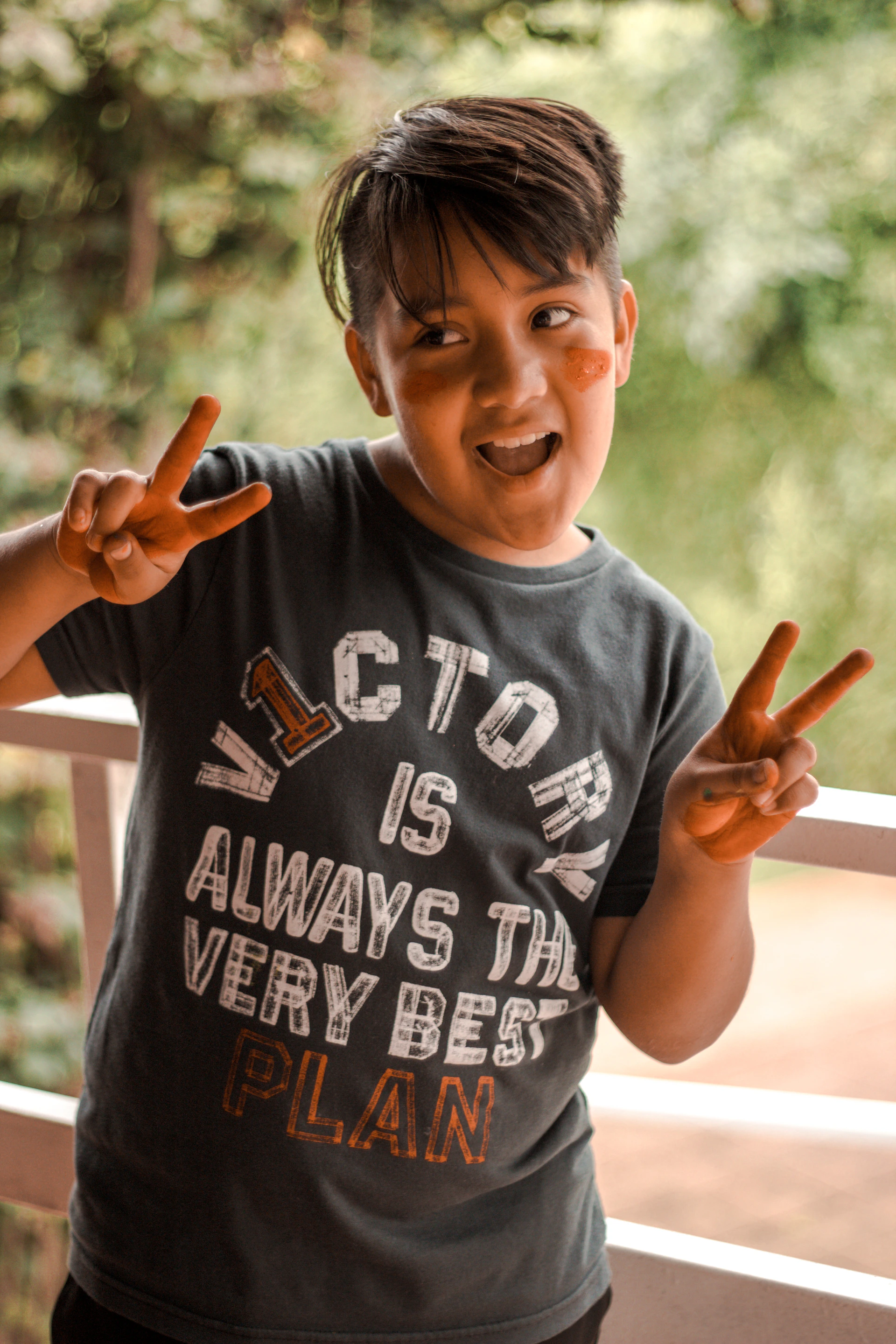 a boy running with his hands up