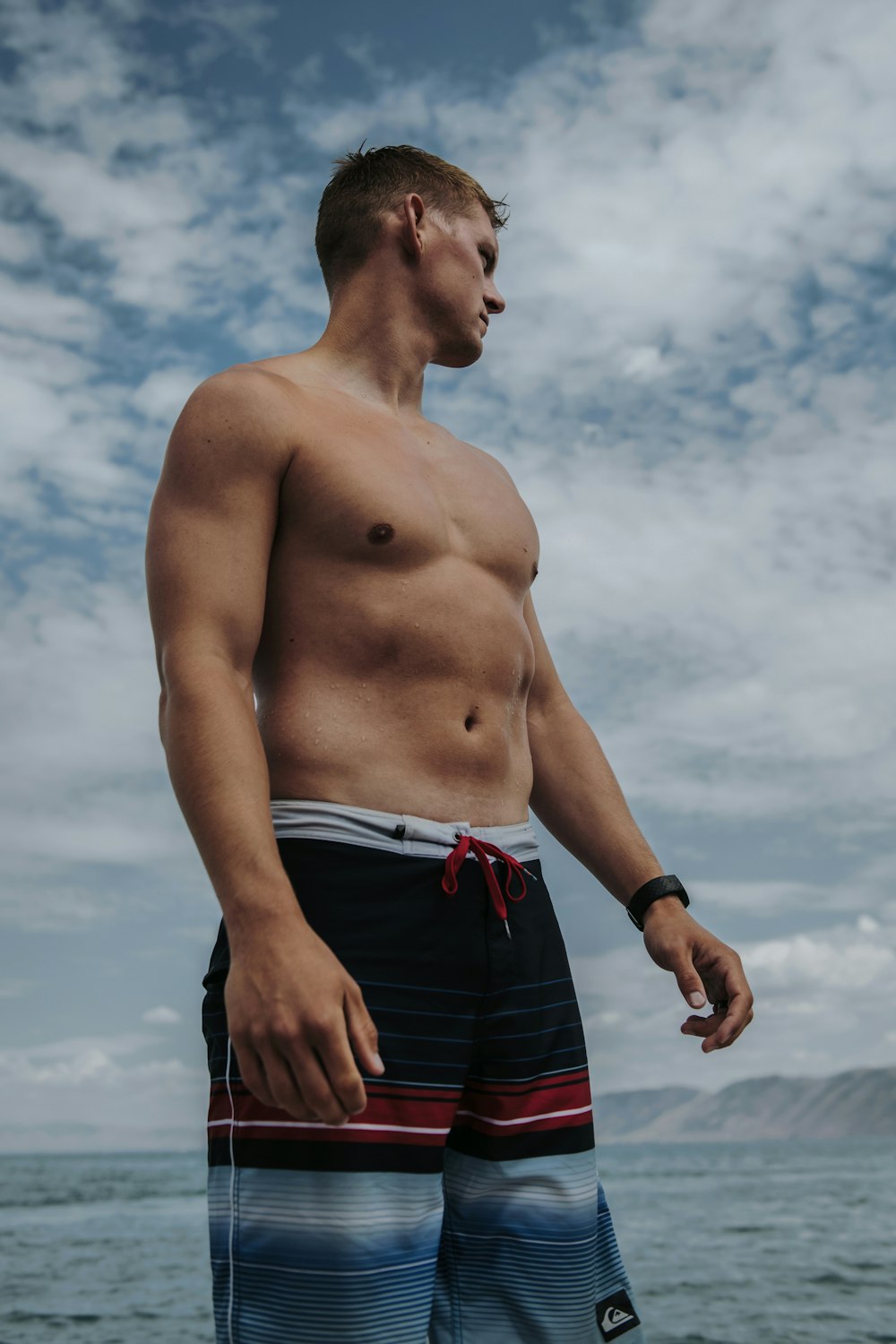 a man standing in front of water