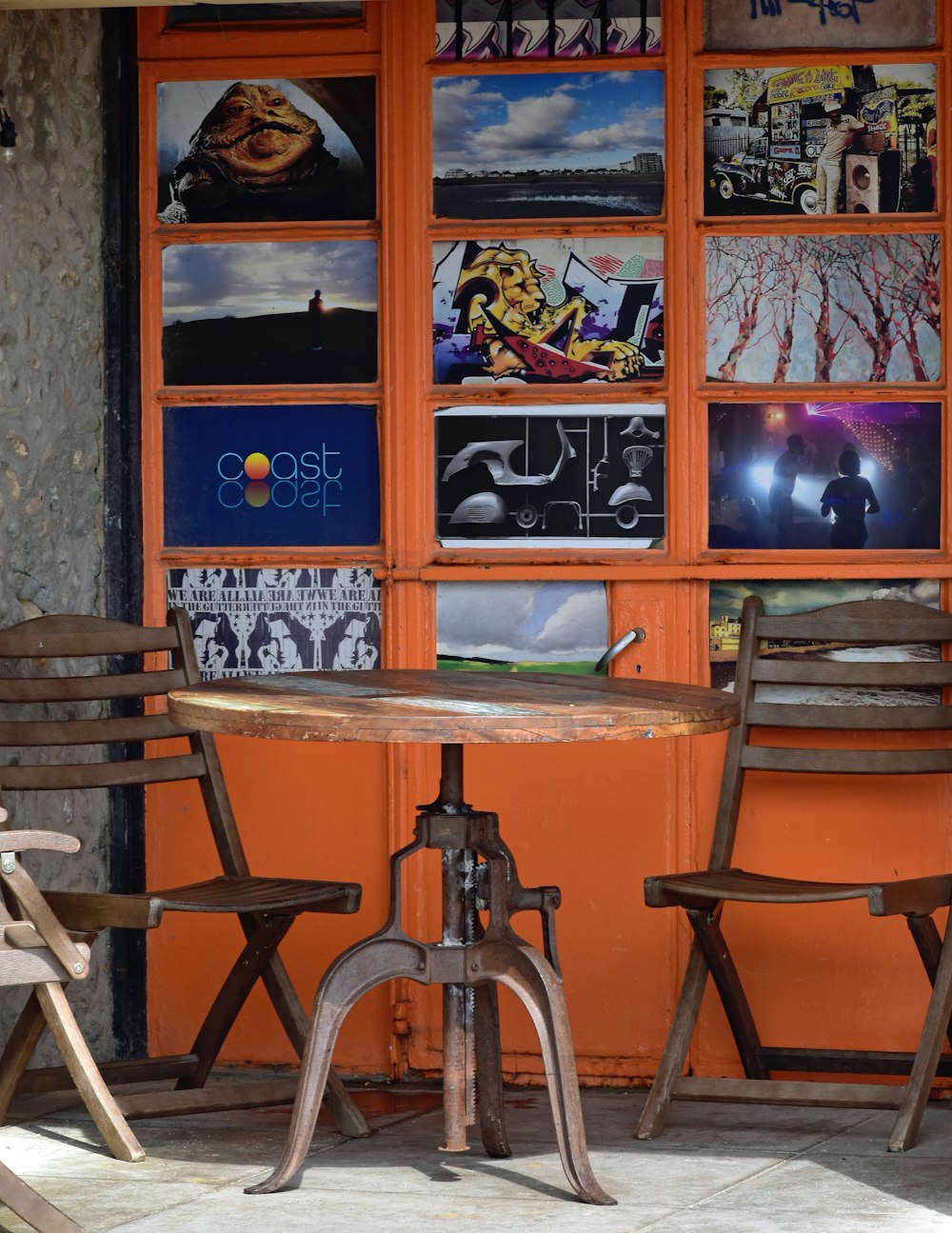 a table with chairs and a wall with pictures on it