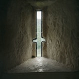 a cross in a stone tunnel