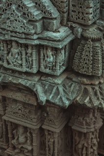 A close-up of intricate carvings on an antique wooden sculpture.