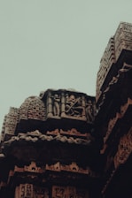 Close-up of intricate carvings on a historic temple wall, telling stories of old.