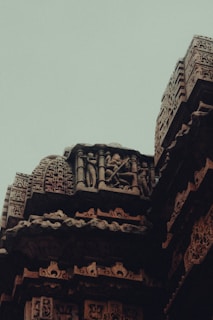 Intricate carvings on the walls of an ancient temple, showcasing centuries-old craftsmanship and devotion.