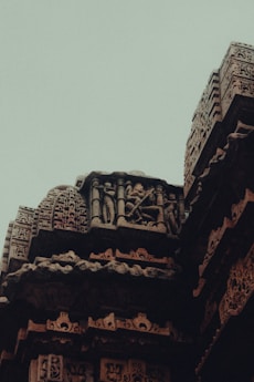 Close-up of intricate carvings on a historic temple wall, telling stories of old.