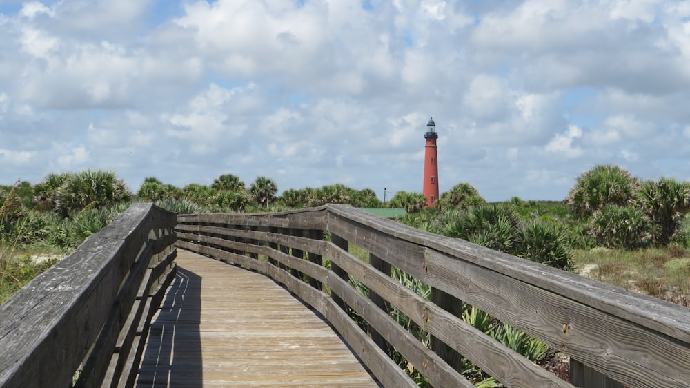 a wooden bridge leading to a lighthouse