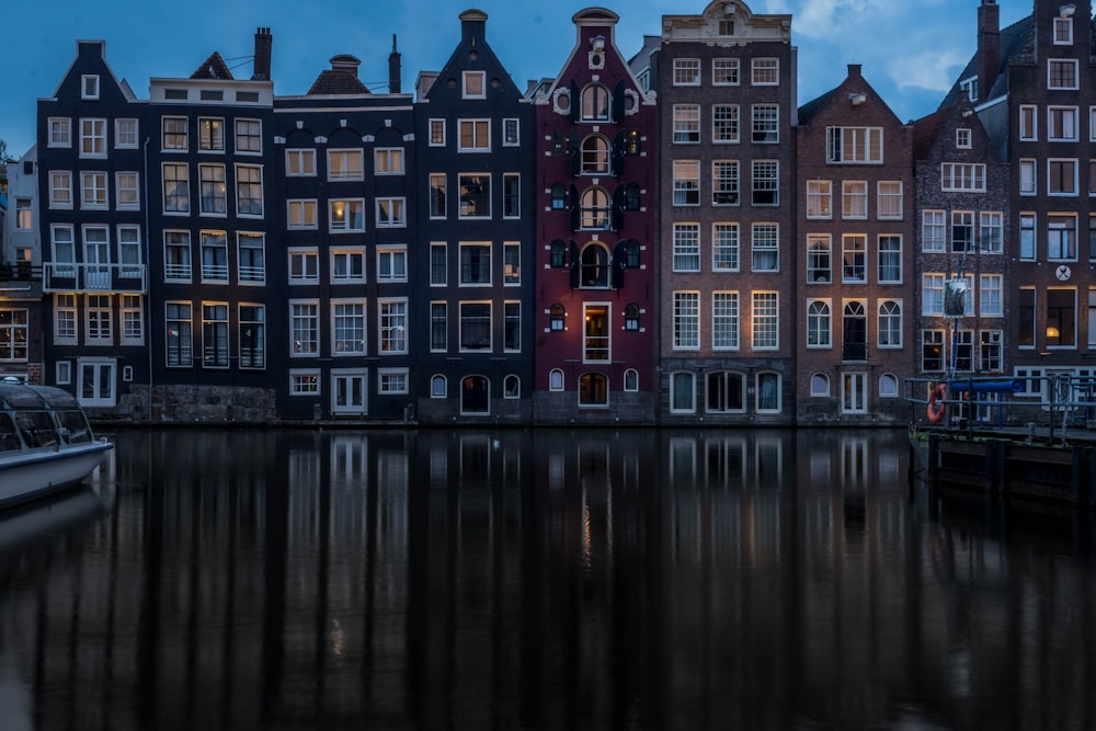 a row of buildings next to a body of water