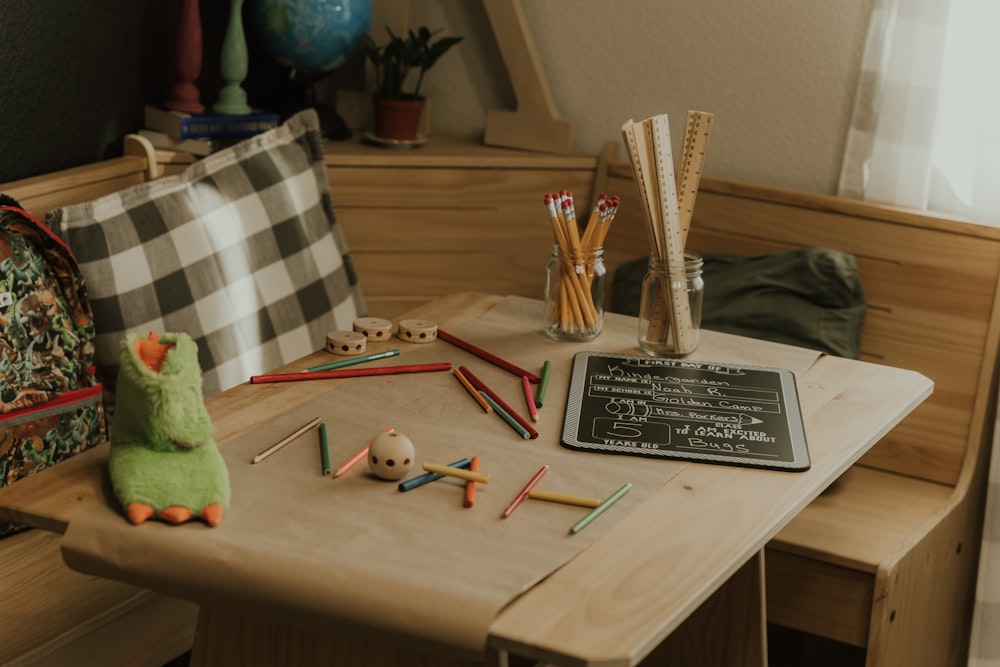 a table with a book and pencils on it