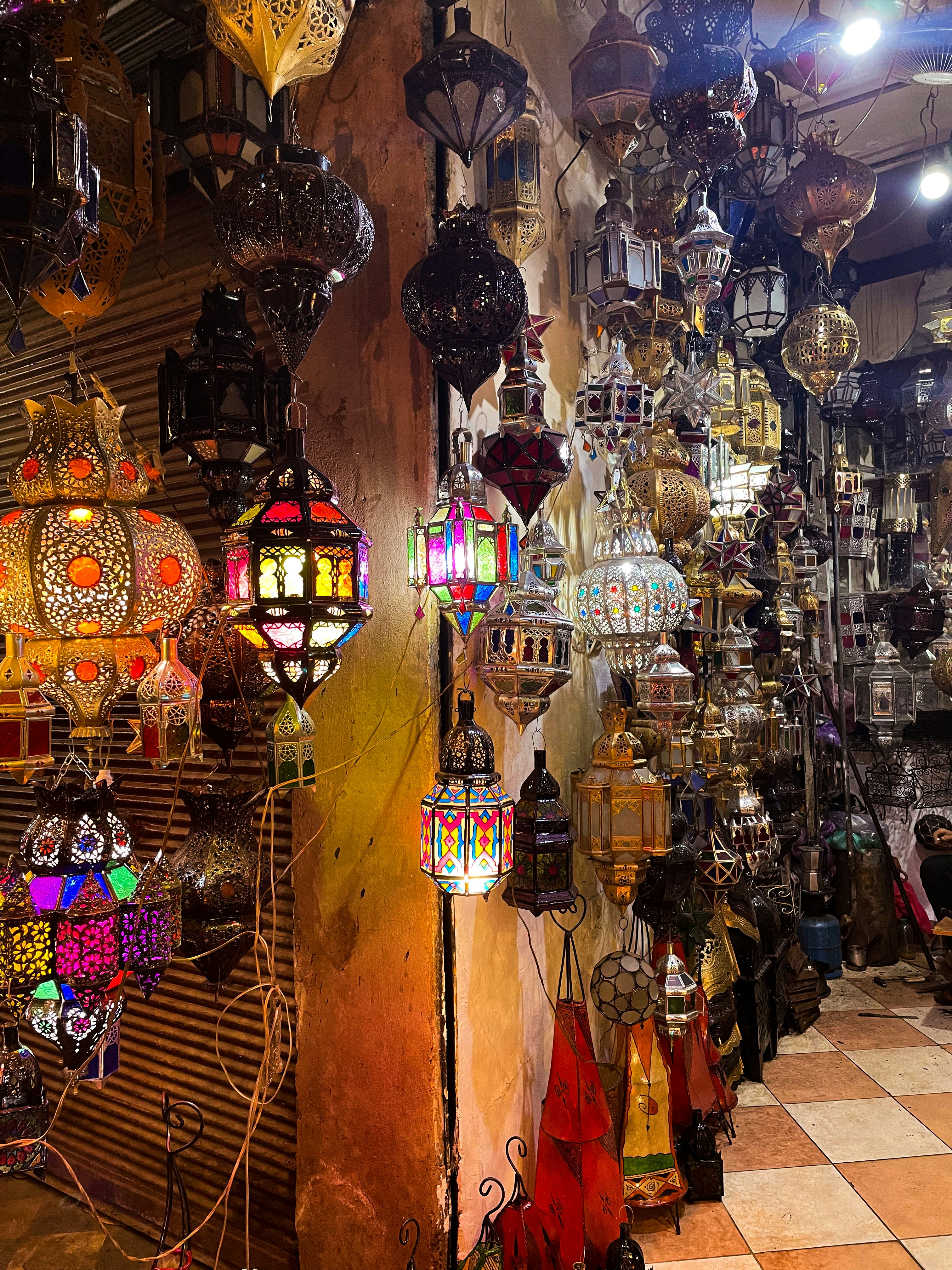 Moroccan lanterns glowing orange and red in a dark souk