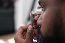 a man using a stethoscope to examine a person's ear