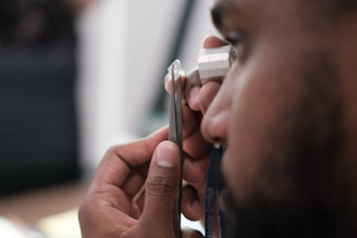 a man using a stethoscope to examine a person's ear