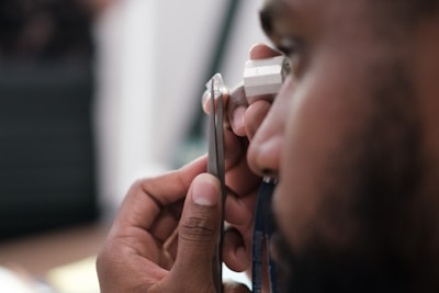 a man using a stethoscope to examine a person's ear