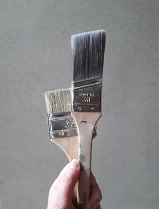 a hand holding a metal object