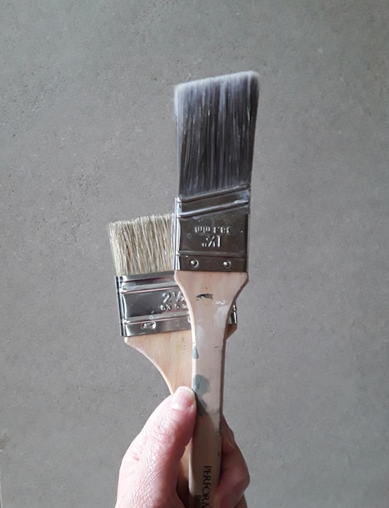 a hand holding a metal object