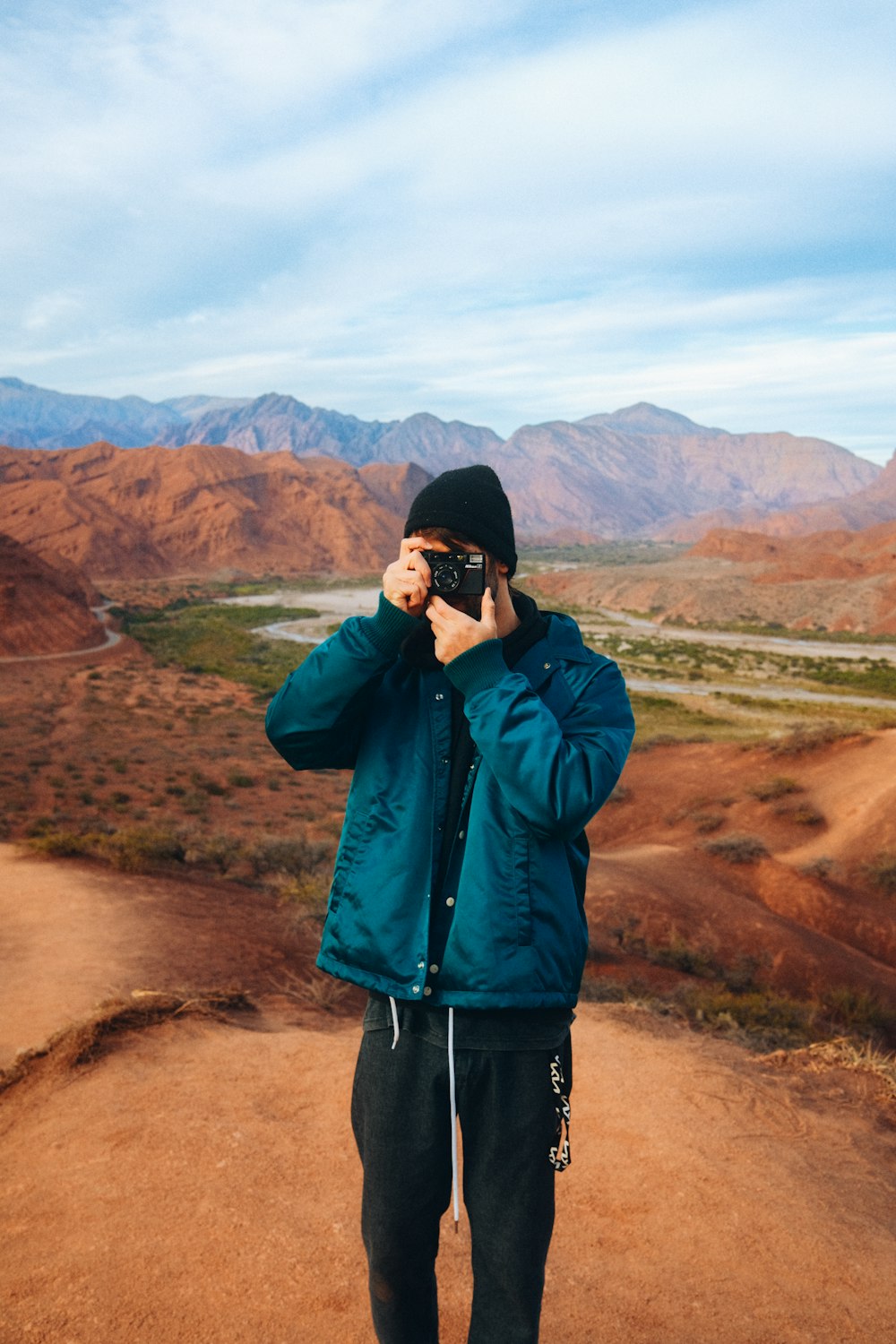 a person taking a picture of a canyon