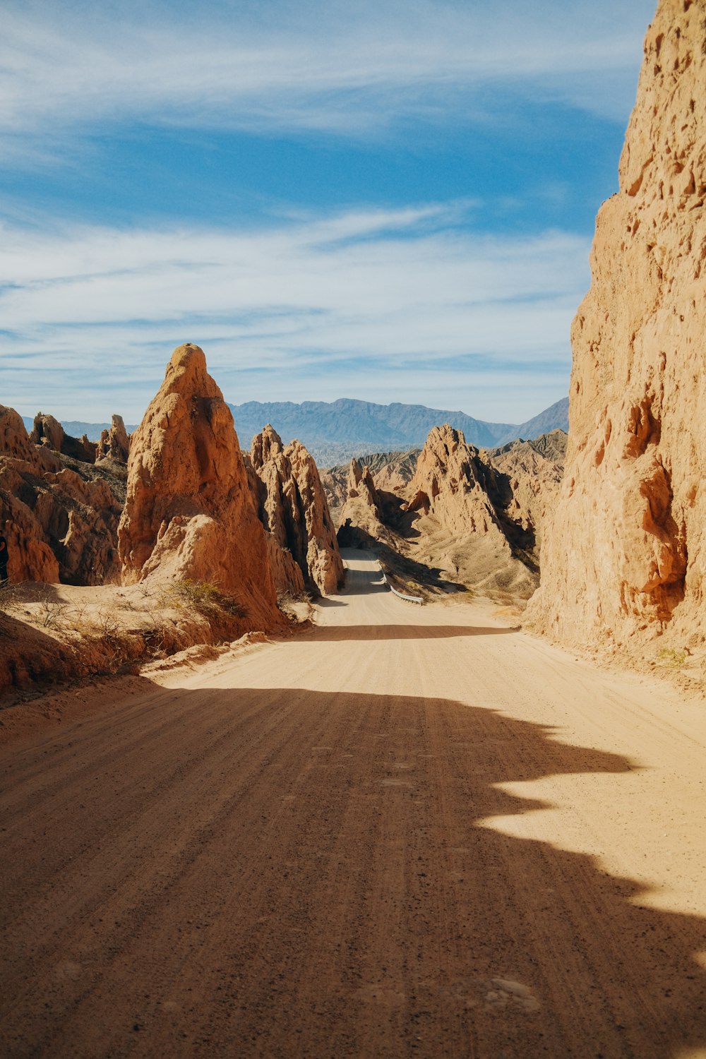 a desert landscape with a dirt road