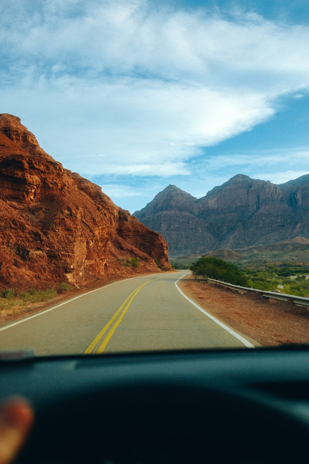 a road with mountains in the background