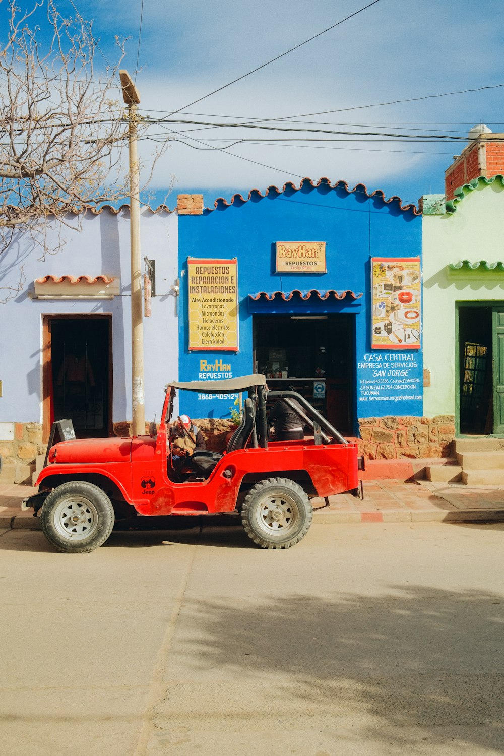 a red vehicle parked outside a building