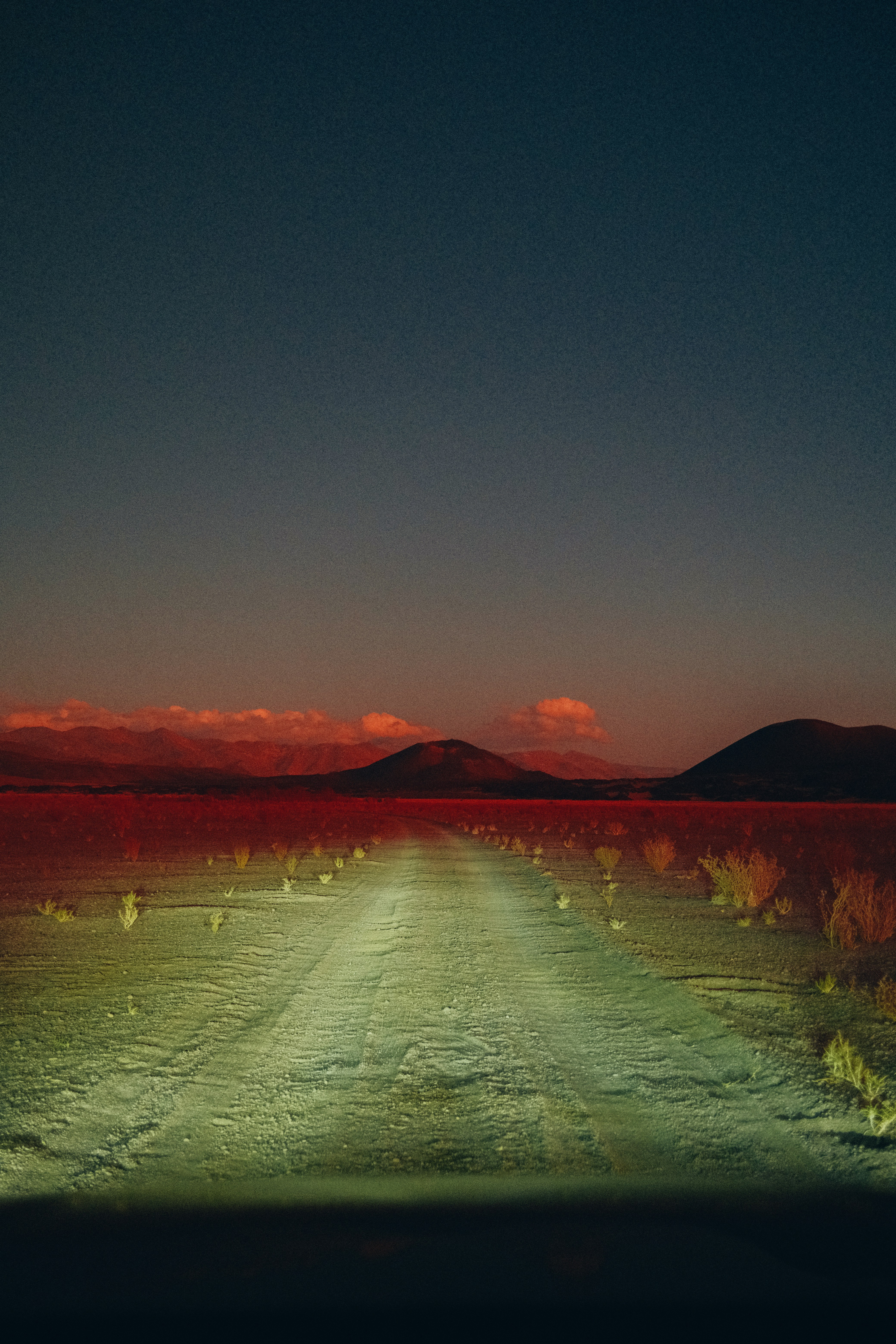 a body of water with hills in the background
