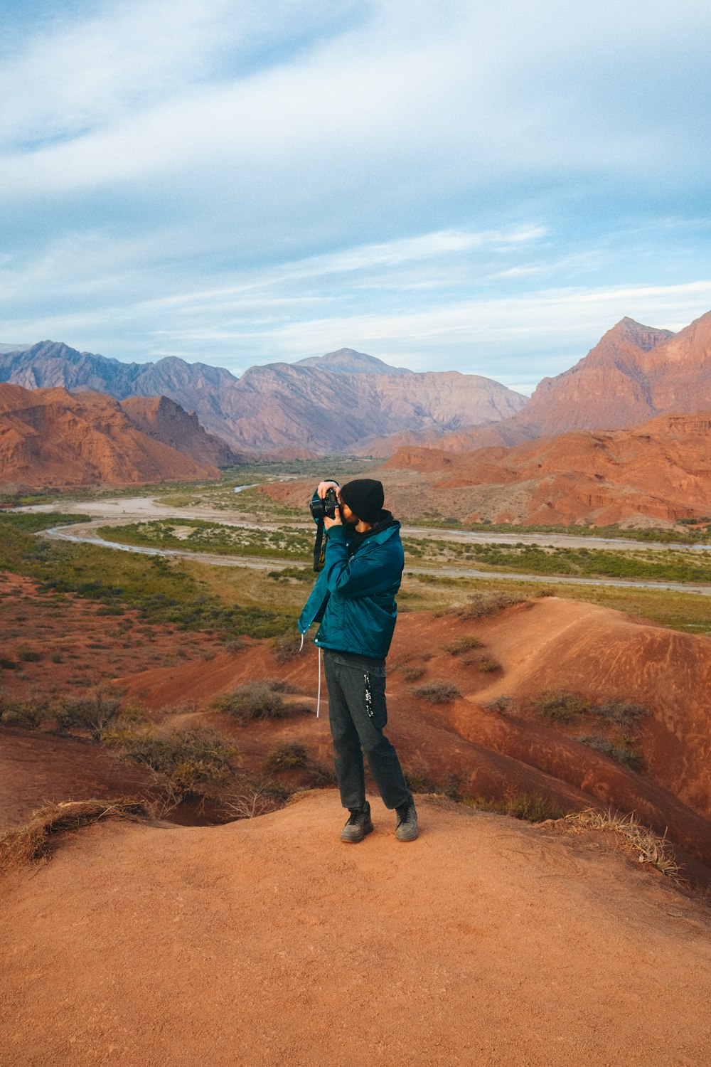 a person taking a picture of a canyon