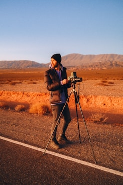 a man standing on a tripod