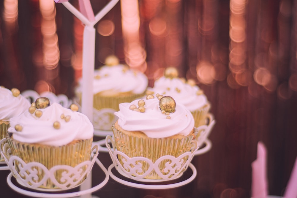 a group of cupcakes with gold decorations