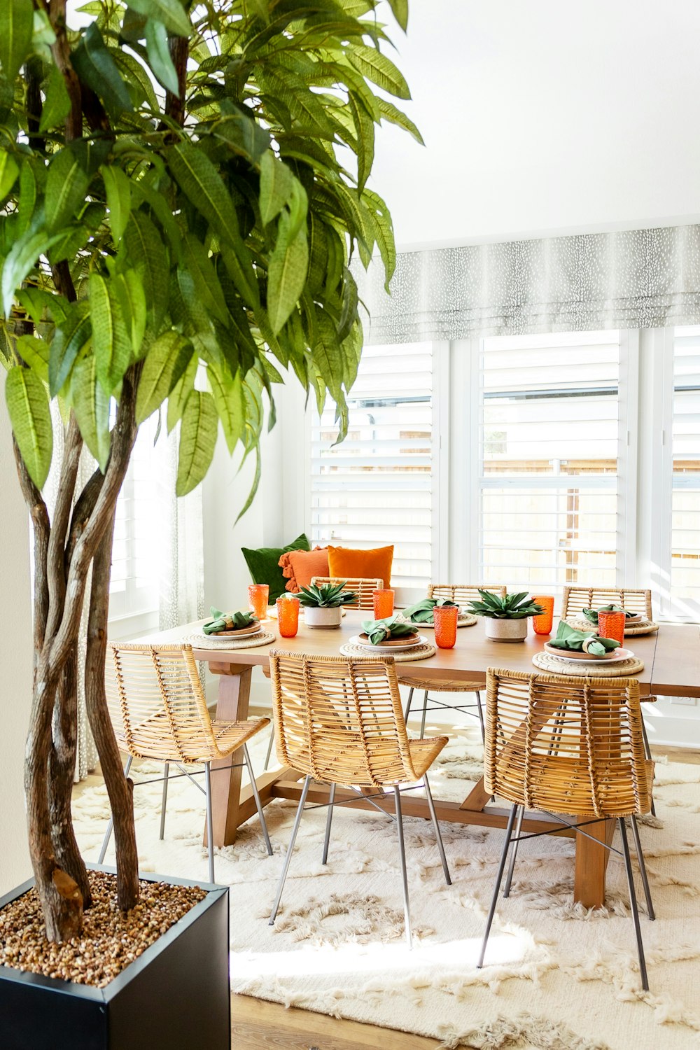 a table with chairs and a tree
