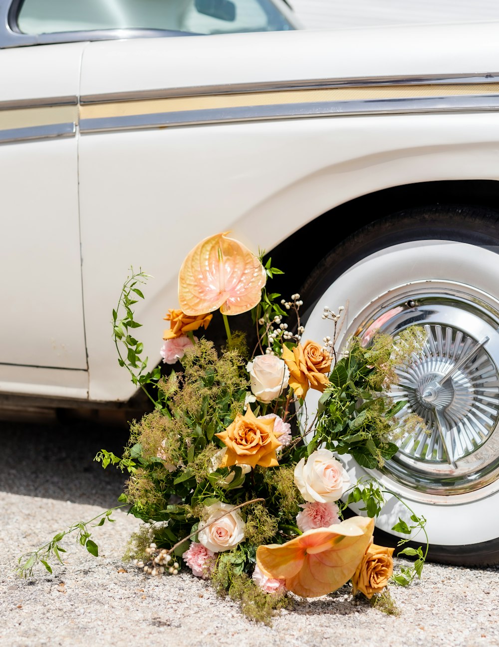 a bouquet of flowers in front of a car