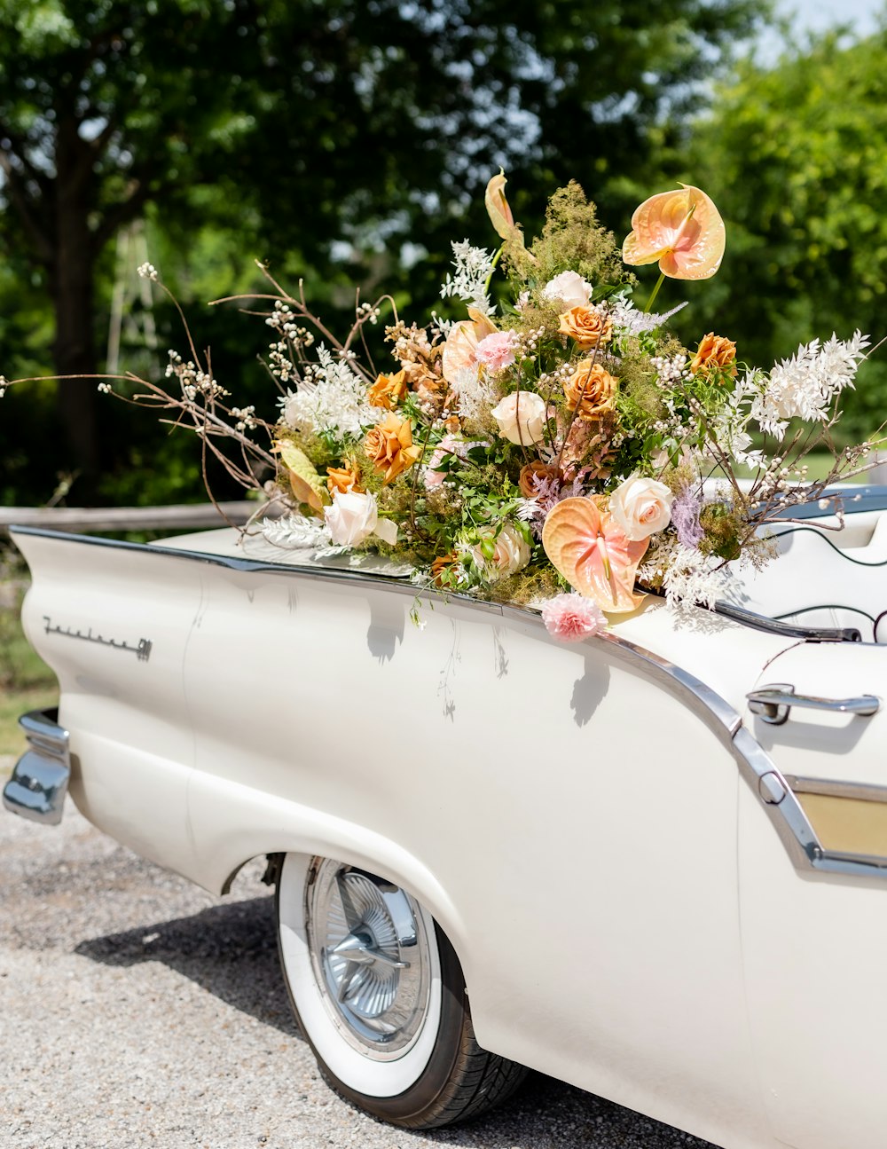 a white car with flowers on the hood