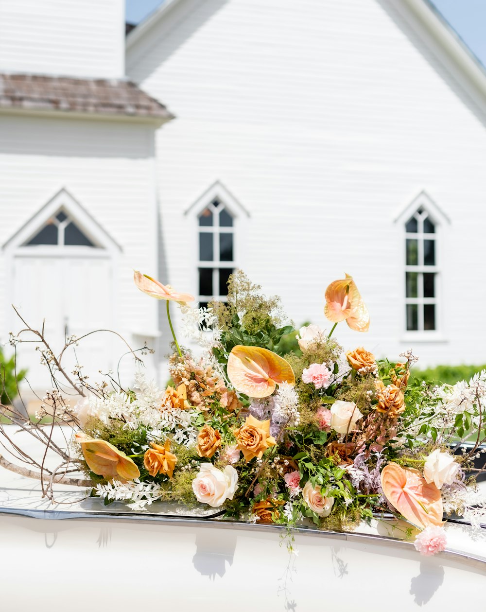 a group of flowers in front of a house