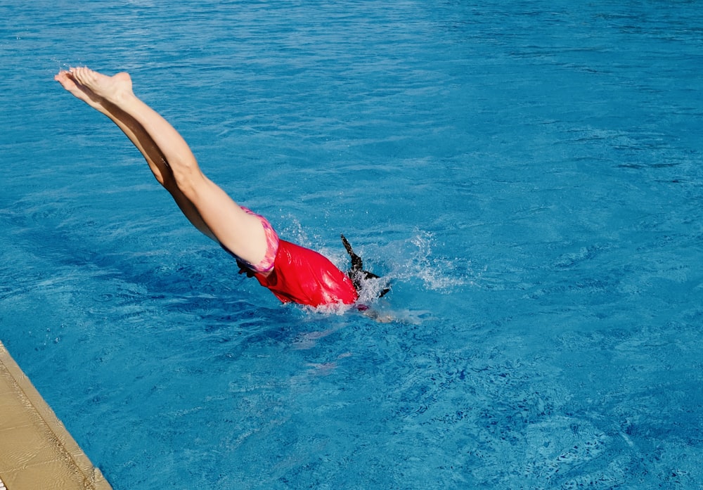 a person diving into a pool