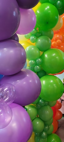 A whimsical balloon centerpiece featuring twisting shapes and playful colors on a party table.