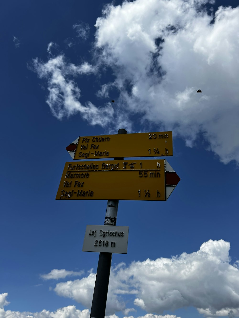 a sign with a bird flying in the sky
