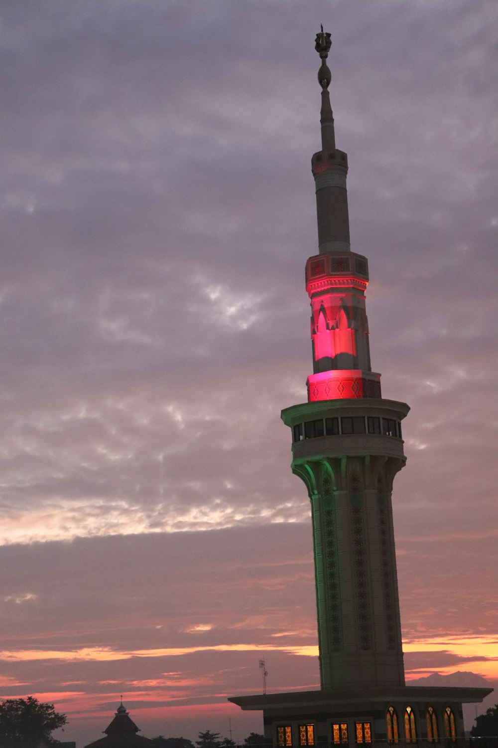 a tall tower with a red and white stripe