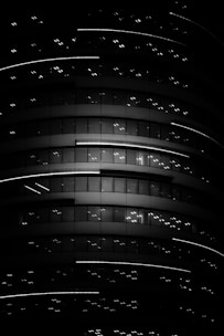 Night scene of illuminated luxury building with minimalist architecture.