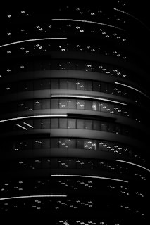 Night scene of illuminated luxury building with minimalist architecture.