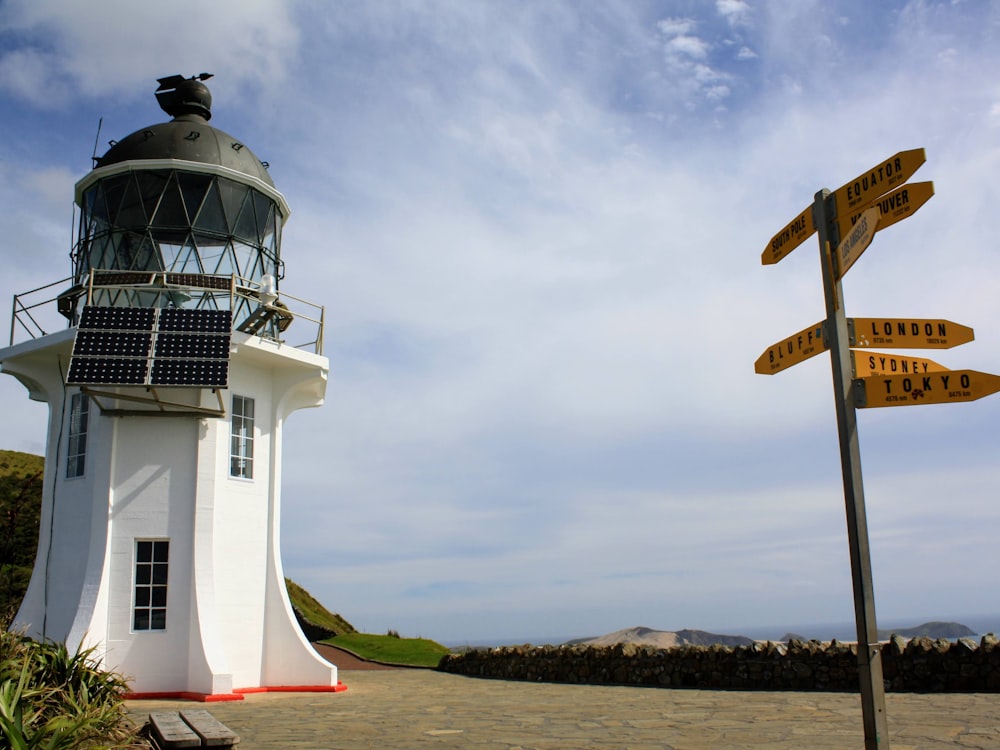 a lighthouse next to a sign