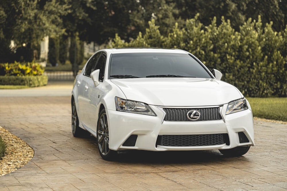 a white car parked on a brick road