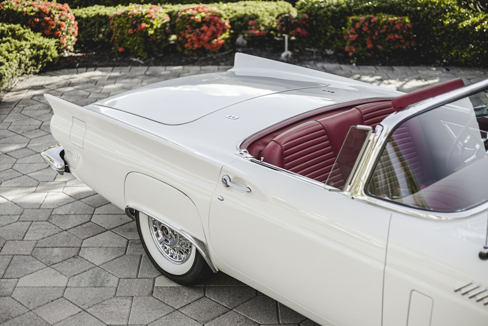 a white car parked on a brick road