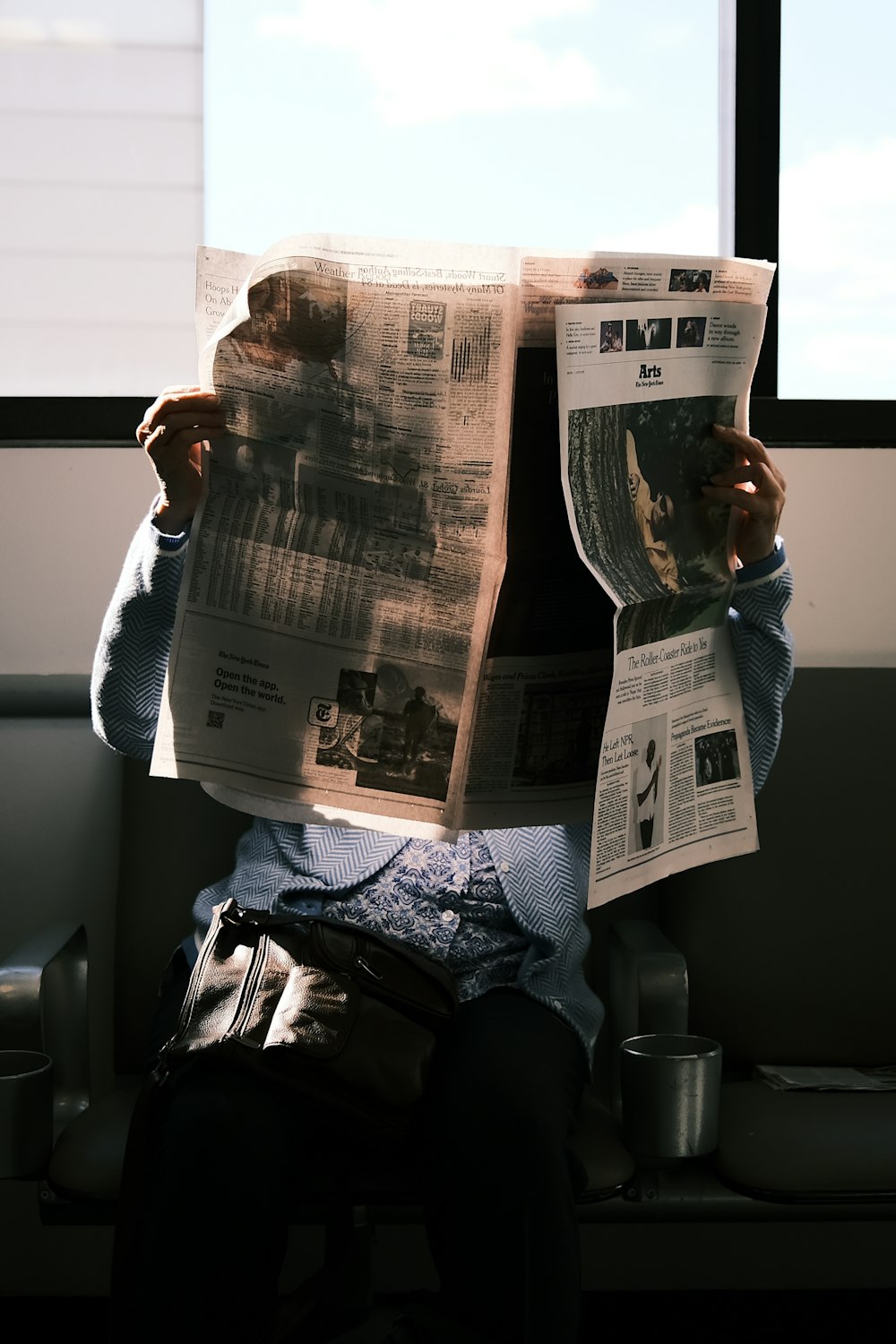 a person reading a newspaper