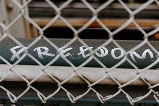 a sign on a metal fence