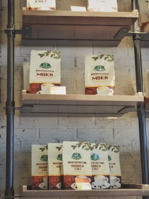 Rows of coffee bags neatly arranged on wooden shelves in the store.