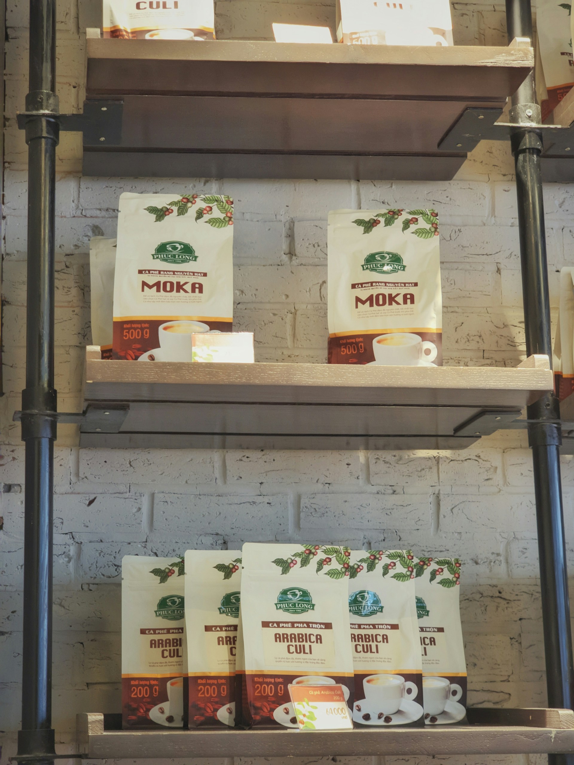 Elegant packaging of Noble Brew coffee bags lined up on a minimalist black and white shelf.