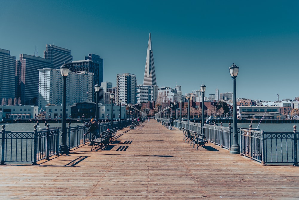 a boardwalk with a city in the background