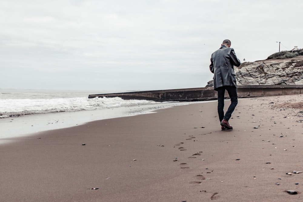 a man walking on a beach