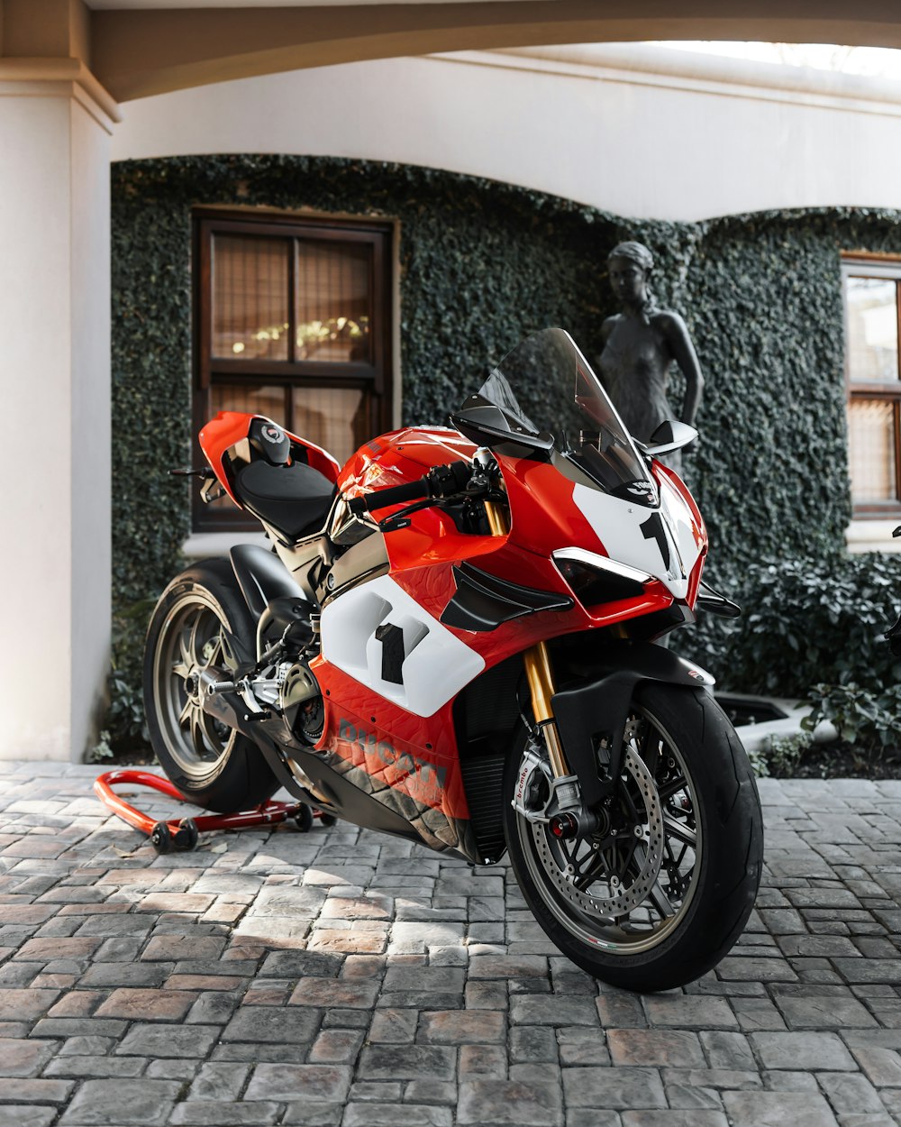 a motorcycle parked on a brick driveway